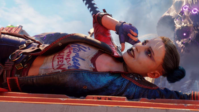 Kill the Justice League's Harley Quinn is lying on her side atop metal bars and miming holding a phone to her ear